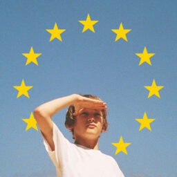 Youth Guarantee Cover - Young person looking far into the distance, the sky with the eu stars behind him